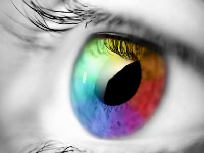 Close up of an eye with rainbow colored iris.